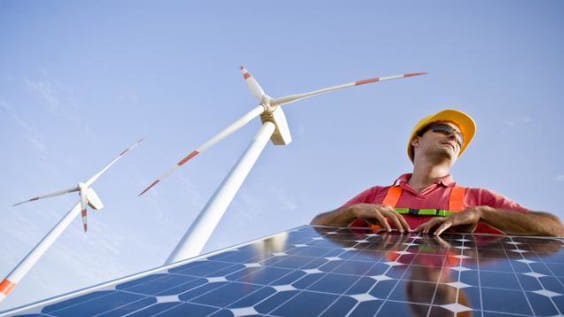Solar panel and windmills in the background