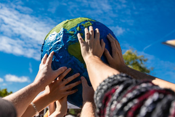 kids hands on the globe